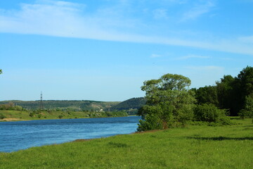 Wall Mural - A body of water with trees and a rainbow in the sky