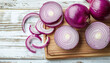 © Nate - Board with slices of fresh red onion on white wooden background