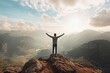 © InnovPixel - Person with arms wide open on mountain top, cloudy skies, freedom concept
