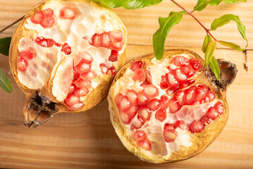 Wall Mural - Pomegranate, a beautiful pomegranate on rustic wood, selective focus.