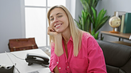 Sticker - Portrait of a smiling caucasian woman in a pink shirt at her office, exhibiting a professional yet approachable demeanor.