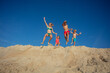 Joyous beach family jump on a sunny day, summer freedom concept