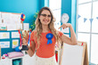 © Krakenimages.com - Young caucasian woman working as teacher at kindergarten holding prize smiling happy pointing with hand and finger