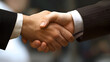 Two businessman in business suits shaking hands, closing a deal