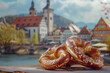 German pretzel pastry with salt, with a typical Bavarian town in the background