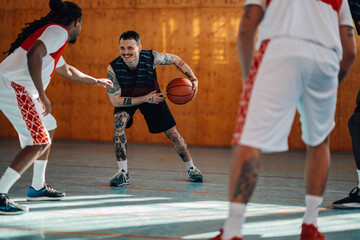 Wall Mural - Portrait of a hispanic tattooed man playing basketball with his diverse team