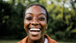 © Vane Nunes - Smiling black young woman looking at camera. Happy confident African student with park city in background. Close up face view portrait
