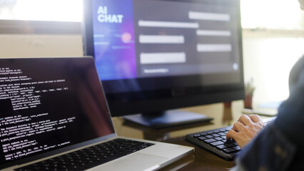 ai chatbot: programmer using artificial intelligence for software development inside office. virtual