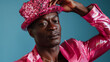© keystoker - African american man dressed in a pink shirt and matching sequined cap, tipping his hat playfully, trend for new masculinity