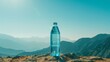 Clear blue water bottle set against a serene mountain landscape under bright sunlight.