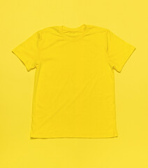 Wall Mural - A bright yellow T-shirt on a bright yellow background.