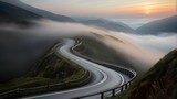 Fototapeta  - : A winding mountain road disappearing into the mis