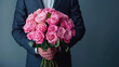 Man holding a big bouquet of pink roses