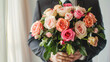 Man wearing suit with a big bouquet of roses