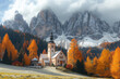  The Dolomites in the autumn, with their towering peaks and colorful trees surrounding St.