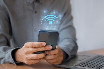 Wall Mural - businessman uses a mobile phone with wifi icon, social business communication concept