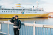 Woman tourist sightseeing Aomori Bay Bridge area with the Hakkodamaru Memorial Ship, Traveler travel in Aomori city, Aomori Prefecture, Japan. Landmark for tourist attraction, travel and vacation