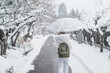 Woman tourist sightseeing Yamadera temple with snow in winter, traveler travel Risshakuji temple in Yamagata City, in Yamagata Prefecture, Tohuku, Japan. Landmark for tourists attraction in Japan