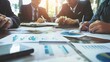© JetHuynh - Business people working together in office. Focus on the foreground. Blurred background.
