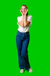 © fotofabrika - Young Woman Poses for Picture against green background.