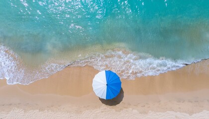 An emerald beach with a beach Umbrella  on it. a summer recreation site, drone shot