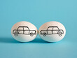 Car crash or accident concept. Insurance and safety. Hand drawn cars on eggs crashed head to head.