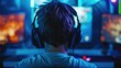 © shelbys - Back View Shot of Young Male Gamer Playing Online Video Game in His Personal Computer at Room Surrounded by Neon Lights, Concept of E-sports and Cybersport.
