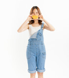 Fototapeta  - Charming joyful girl holding juicy orange on white background, vitamins for healthy skin.