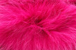 Texture of bright pink faux fur as background, closeup
