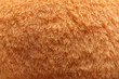 Texture of orange faux fur as background, closeup