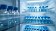 Pristinely organized medical vials in a cool-toned, illuminated laboratory fridge.