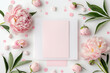 Greeting card mockup, empty pink card with peonies flowers on pink background. top view flatlay. Card mockup with copy space. Mother's day, Birthday card	