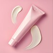 A tube of cream is on a pink background with a white cream swirl