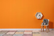 © New Africa - Beautiful children's room with bright orange wall and furniture, space for text. Interior design