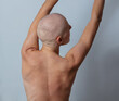 Bald bare chest woman struggle with cancer view from the back