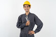© Pormezz - Repairman mechanic, Asian young handyman holding tools and wearing yellow safety helmet isolated on background.
