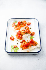 Canvas Print - Roasted white fish with tomatoes and basil