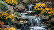 Waterfall in the garden, rocks and flowers in autumn colors, golden yellow foliage