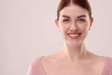 Poster - Portrait of smiling woman on light background. Space for text