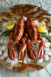 Three lobsters are on a plate with lemon slices and ice