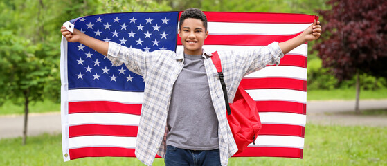 Wall Mural - African-American student with USA flag outdoors