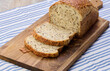 Sliced ​​white wheat flour bread with flax seeds on a wooden board