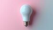 © antkevyv - Light bulb, calm and peaceful mood with light bulb on pink background, still tranquility understanding wisdom bright