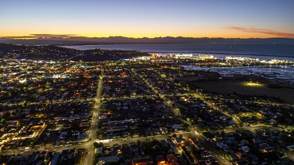 Wall Mural - Evening aerial timelapse over coastal city of Nelson, New Zealand, city traffic.