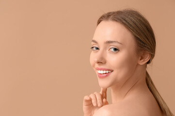 Wall Mural - Beautiful young woman on brown background