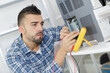 man using multimeter to test electrical appliance