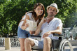 man in wheelchair and girlfriend on holidays looking at map