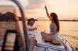 Couple having fun drinking champagne while sailing on a boat