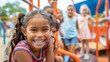 © AiDesign - happy smiling girl playing in playground with friends looking at camera