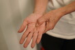 © kiattisak - A woman uses her other hand to feel pain. and tingling along with symptoms of numbness in the hands Elderly woman tries to massage herself to relieve wrist pain